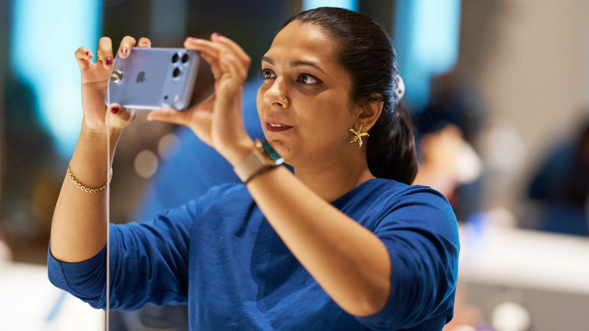Official Apple BKC photograph of a customer using an iPhone 18 Pro in Mumbai