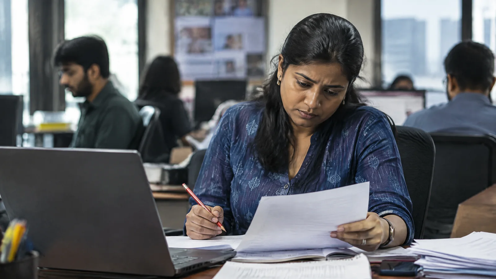 A newsroom editor carefully fact-checking a report